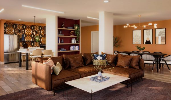 Modern open-plan living area with brown sofa, dining table, and patterned kitchen accent wall.